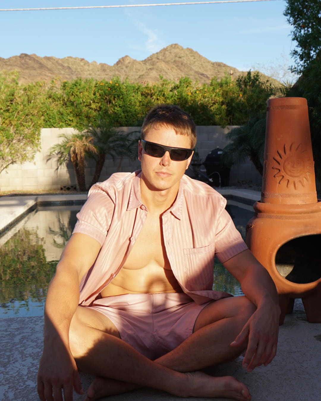 Kiefer Wiedmaier seated poolside at golden hour in Phoenix, Arizona