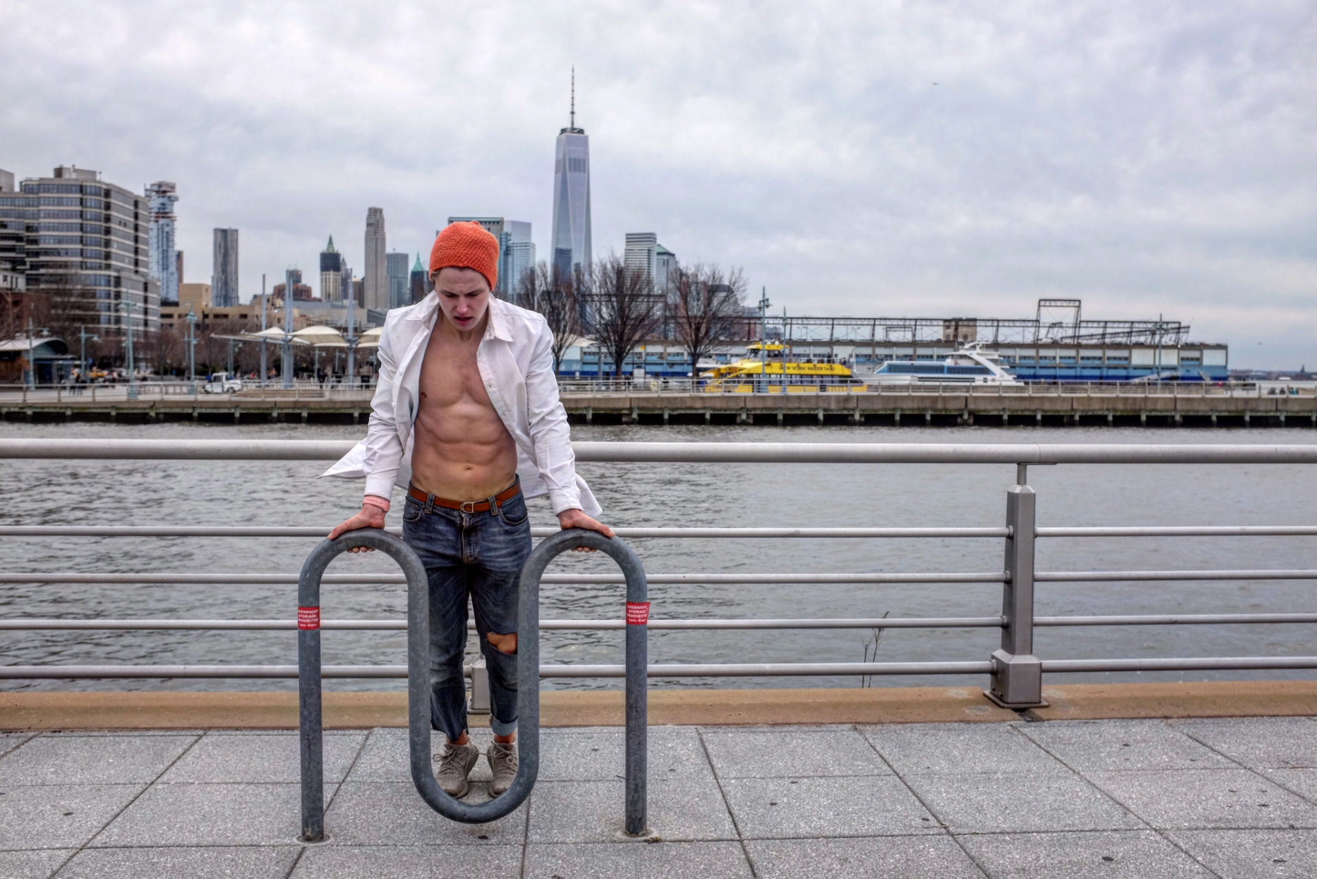 Bodyweight dips on a waterfront rail with the city skyline behind